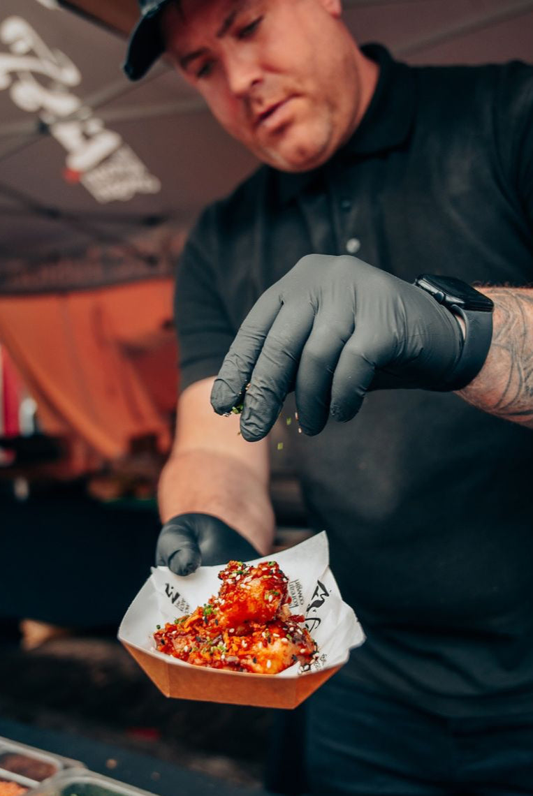 korean cowgirl's chef John bungle is garnishing wings at wingjam London, WingJam London A Fun and Flavorful Gathering of Friends, WingJam London People Relishing Every Wing Bite at the Festival, WingJam London A Celebration of Chicken Wings and Good Times, WingJam London The Ultimate Wing Lover’s Event for Friends, WingJam London A Fun Day Out for Food Lovers and Friends, WingJam London Where Flavor and Friendship Meet Over Wings, WingJam London A Celebration of Delicious Wings with Friends, WingJam London