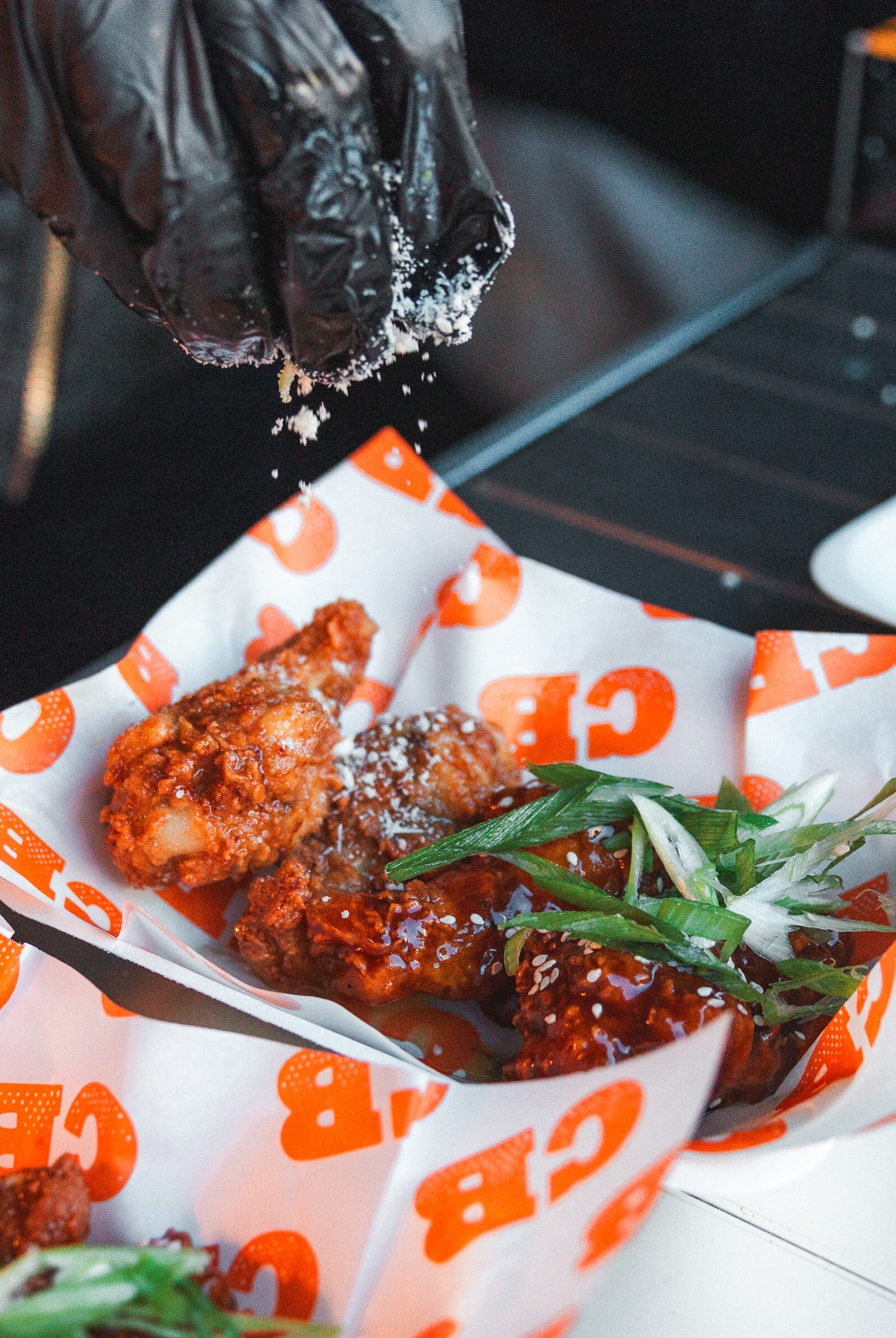 chicken wing are being seasoned at wingjam, wingjam 2024 the ultimate chicken wing event, top wing slingers in action at wingjam