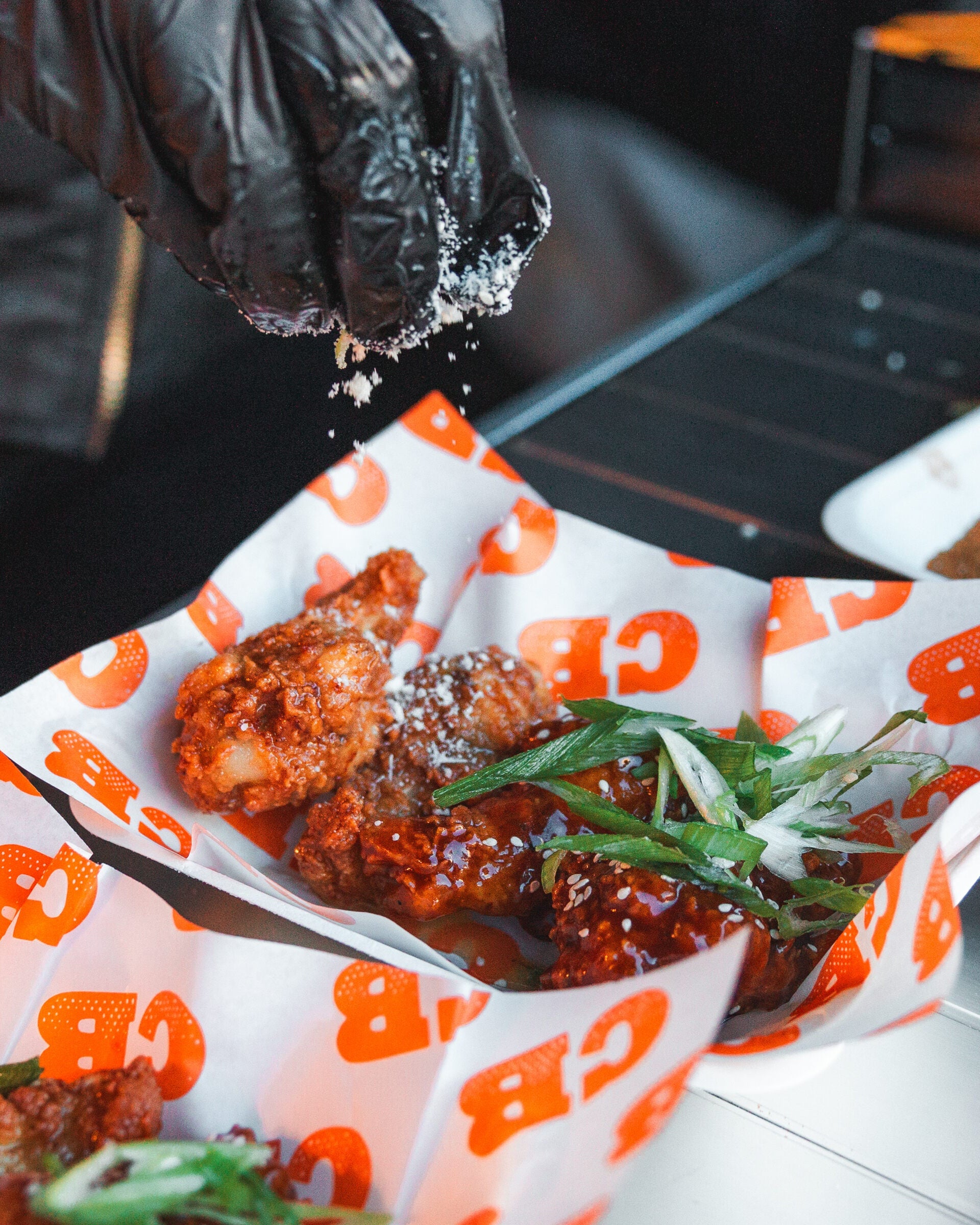 chicken wing are being seasoned at wingjam, wingjam 2024 the ultimate chicken wing event, top wing slingers in action at wingjam