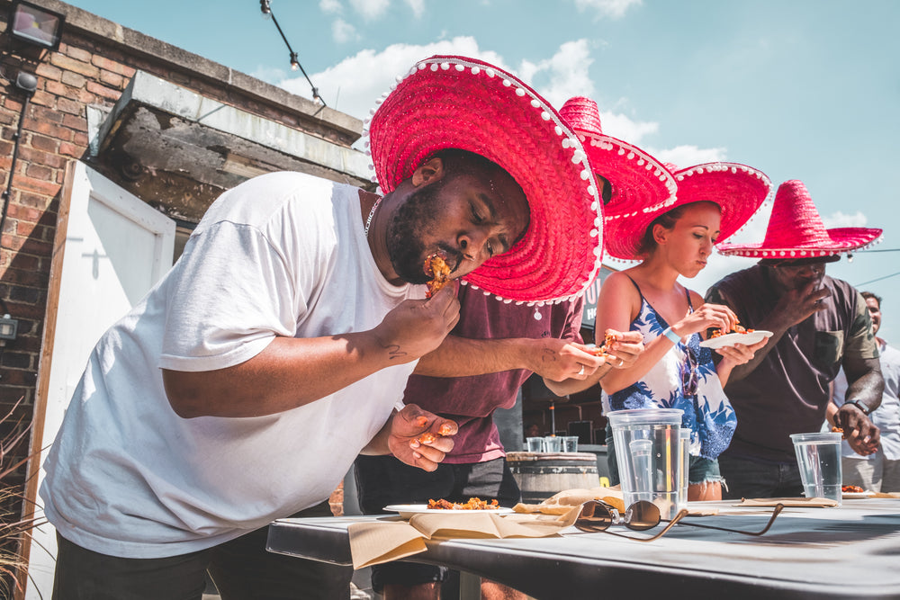 a guy winning a hot wing contest
