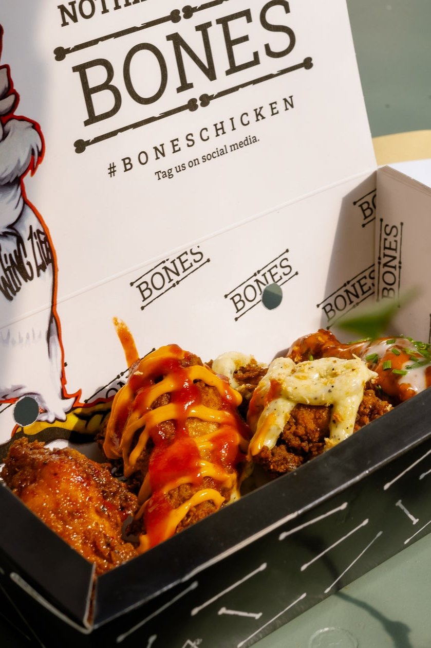 a box of mouthwatering wings from bones at wingjam 2024, WingJam London A Fun and Flavorful Gathering, WingJam London Best Festival for Wing Lovers, WingJam London People Enjoying Every Bite Together, WingJam London A Celebration of Food and Friendship, WingJam London The Ultimate Wing Lover’s Festival, WingJam London Where Friends Savor Every Wing