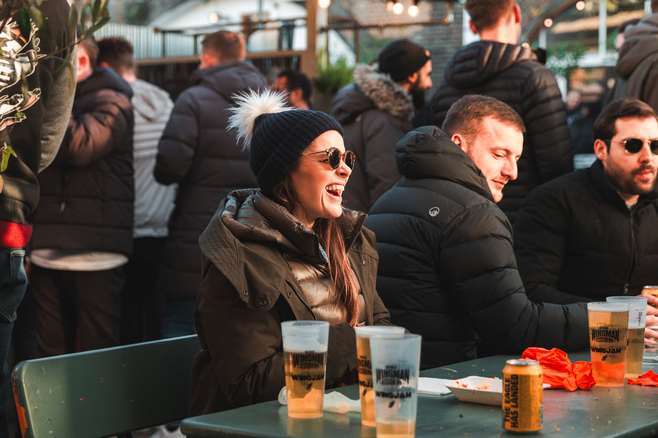 a girl having a great time at wingjam , WingJam London A Celebration of Great Food and Friendship, WingJam London The Best Place for Wing Fans and Foodies, WingJam London A Fun and Flavorful Gathering of Friends, WingJam London People Relishing Every Wing Bite at the Festival