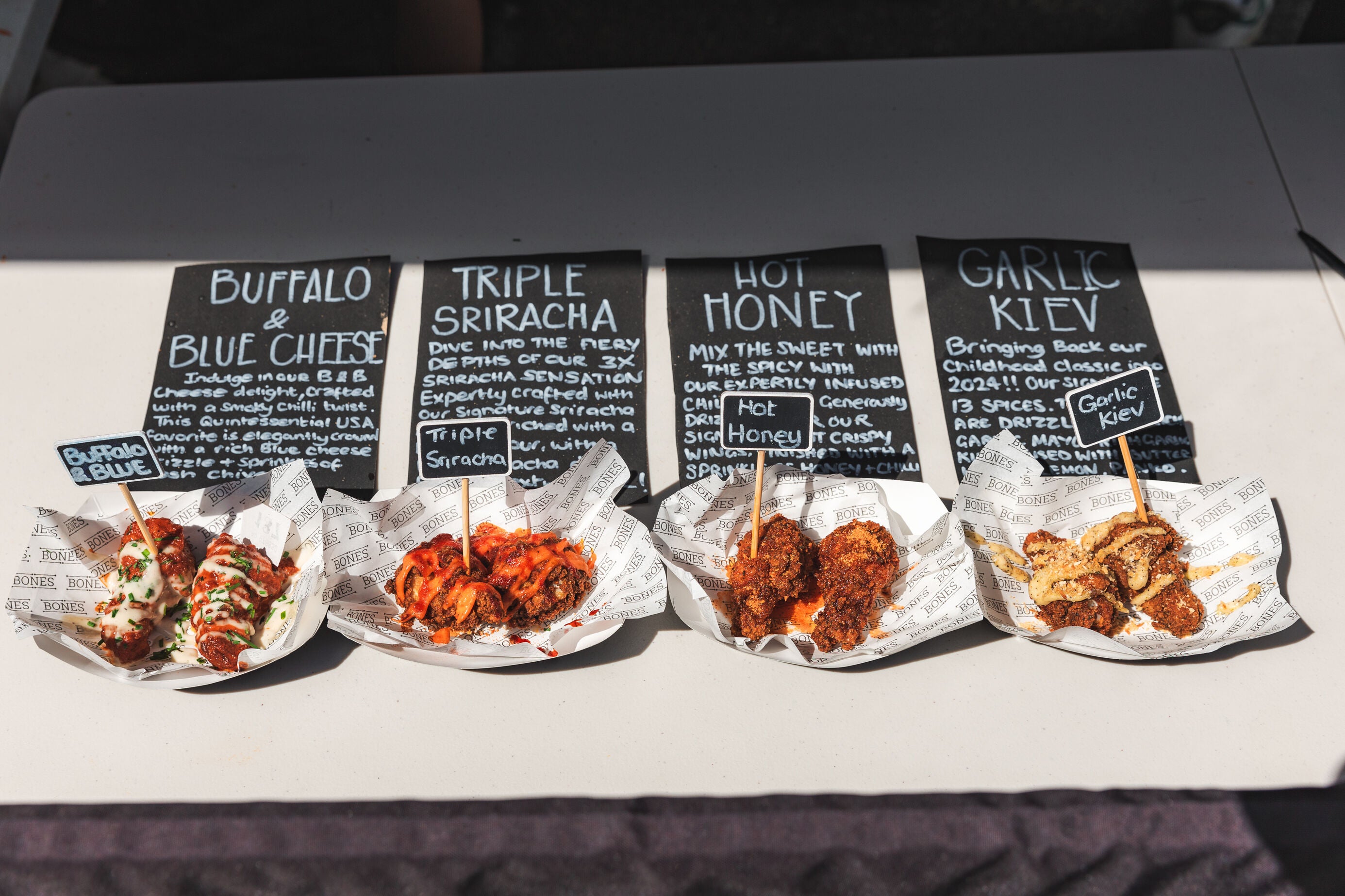 chicken wings from bones at wingjam 2024, WingJam London A Tasty Adventure for Food Lovers, WingJam London Festival of Fun and Flavor, WingJam London People Loving the Festival Atmosphere, London WingJam Friends Eating and Enjoying Chicken Wings, WingJam London Where Crowds Savor Every Bite