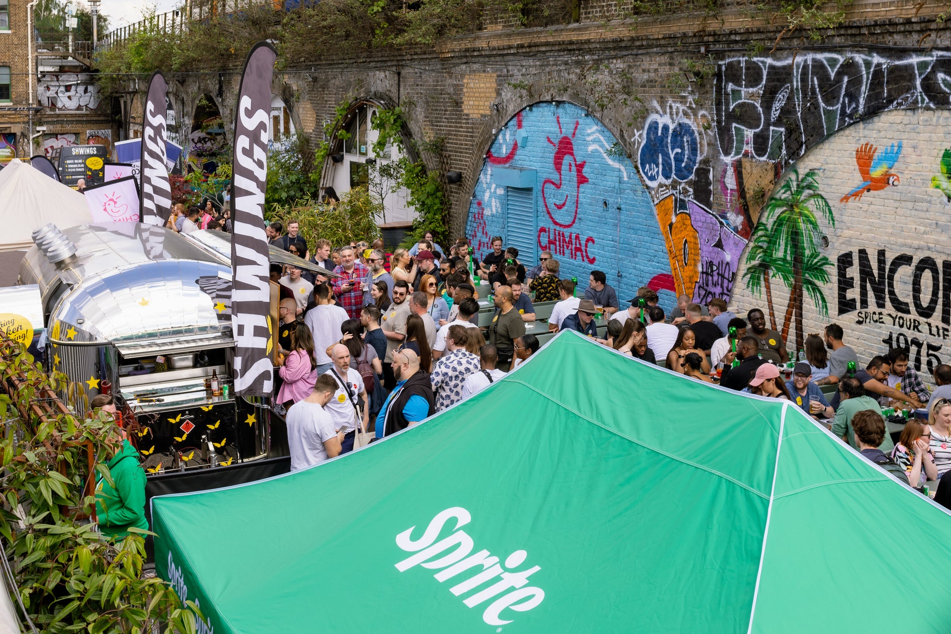 panoramic view to wingjam chicken wing festival at peckham arches 2024, WingJam London Best Chicken Wing Event for Friends and Foodies, WingJam London A Festival of Great Food and Great Company, WingJam London People Enjoying Every Bite Together, WingJam London A Flavor-Packed Gathering for Wing Lovers