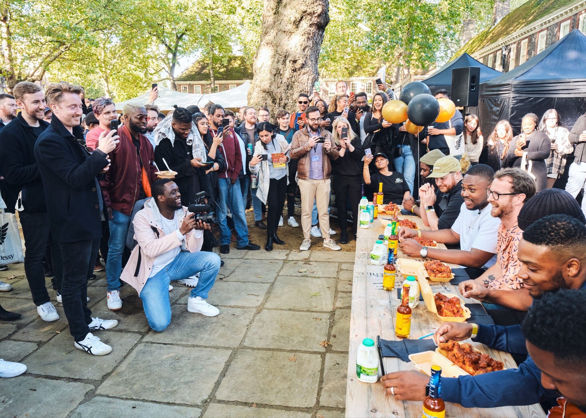 people supporting hot wing contestants at wingjam , Ultimate Chicken Wing Experience at WingJam London, Best Food Festivals in London WingJam, Fun Events in London This Month WingJam