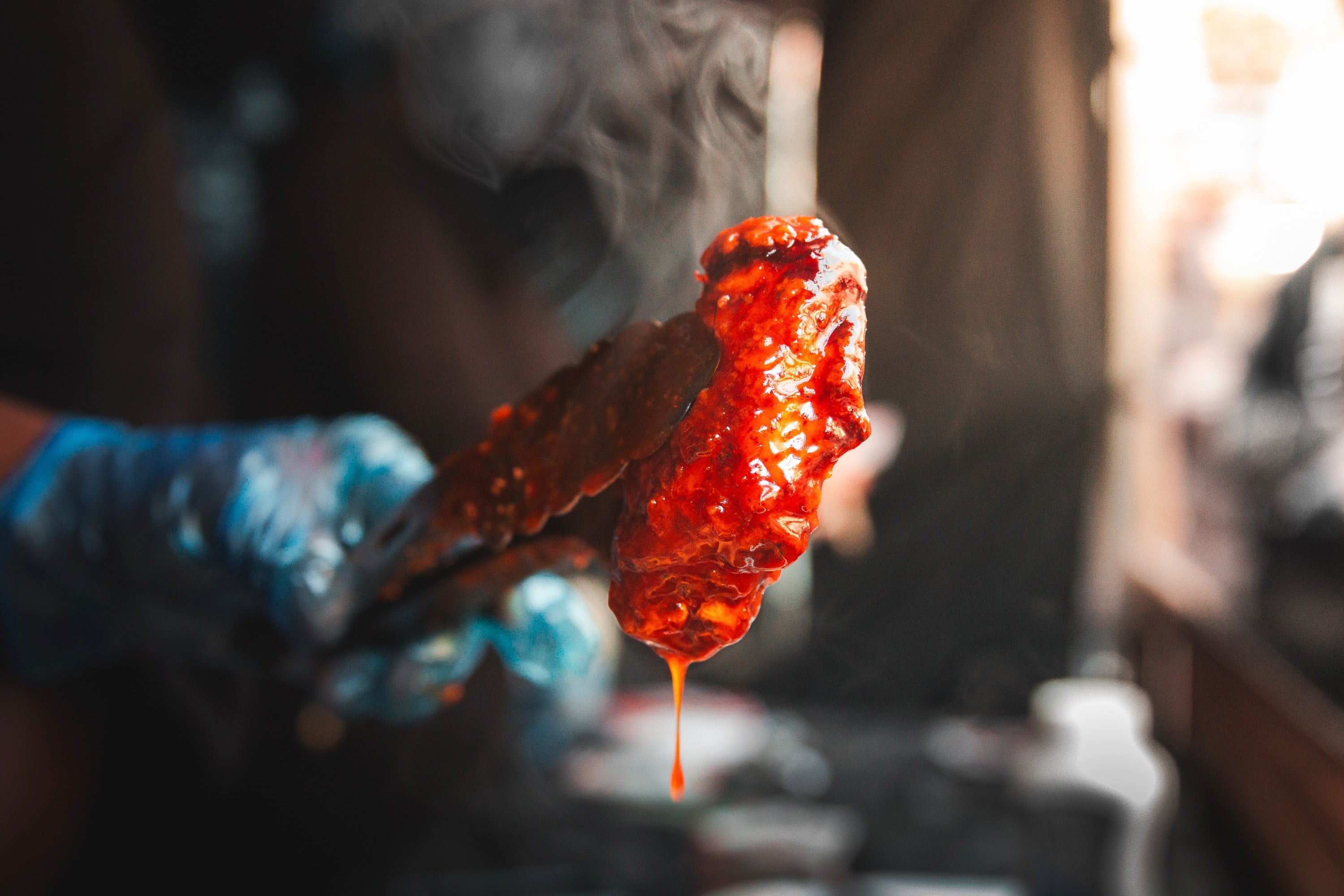 sauce dripping from delicious chicken wing at wingjam, WingJam London A Celebration of Flavor and Fun, London’s Best Wing Event WingJam 2024, WingJam London Top Choice for Chicken Wing Lovers, WingJam Festival 2024 London Ultimate Chicken Wing Experience