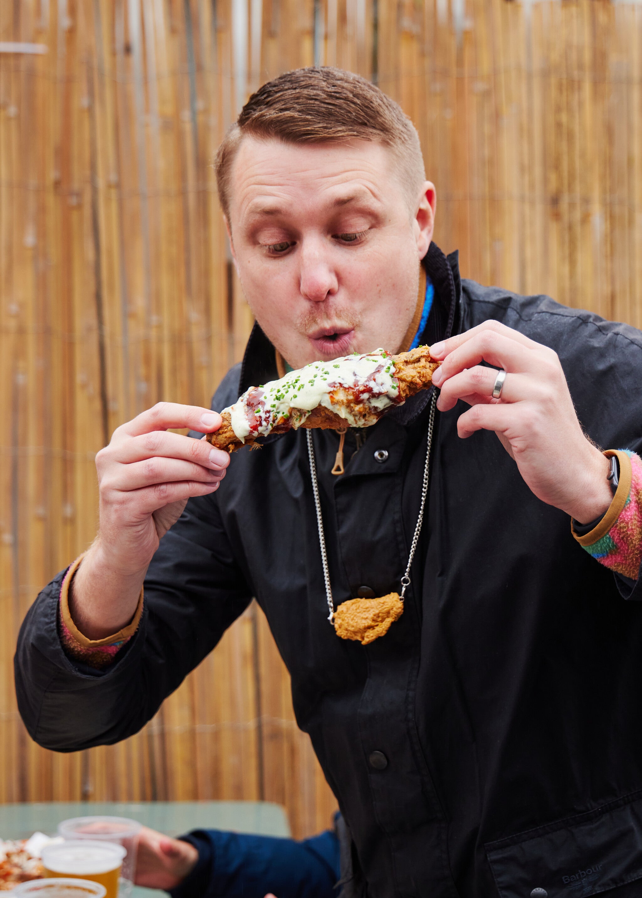 the guy eating a huge turkey wing at wingjam, WingJam London Must-Visit Food Festival, London Food Festivals WingJam 2024, WingJam Festival London Best Chicken Wings and Fun, 
